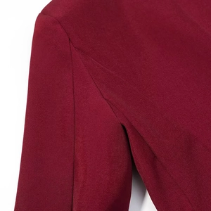 Close-up of shoulder seam stitching and fabric texture on a wine red slim blazer