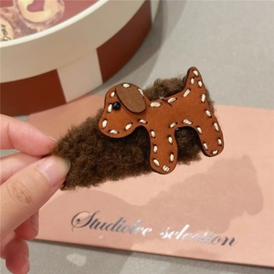 Detailed close-up of brown plush puppy shark clip with handmade stitching and leather texture