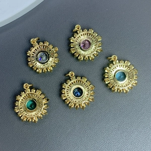Set of five gold sunflower pendants with colorful zircon crystals for jewelry making