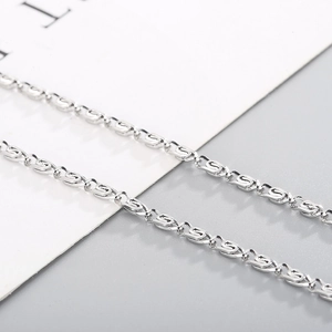 Macro shot of silver stainless steel paperclip chain links with fine interlocking texture