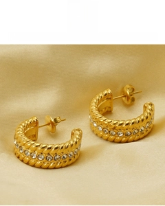 Detail of 18K gold plated twisted hoop earrings with sparkling cubic zirconia inlay