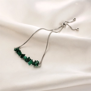 Detail of adjustable silver box chain bracelet with natural green crystal chips