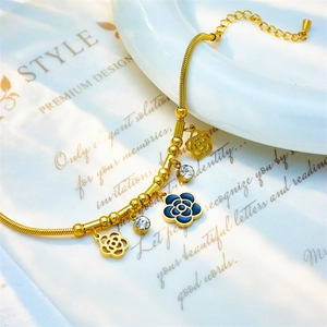 Golden camellia flower charm bracelet with rhinestones and vintage enamel details