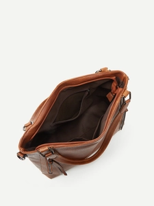 Detail view of brown tote bag interior with zipper pocket and lining texture