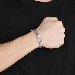 Close-up of a men's silver double wolf head bracelet with a heavy rock hip-hop style