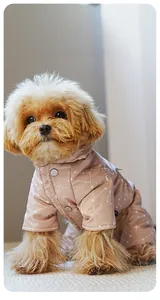 Close-up of pink dog winter jumpsuit with star patterns and snap button closure