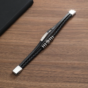 Detail of multi-layer black braided leather bracelet with silver alloy magnetic buckle