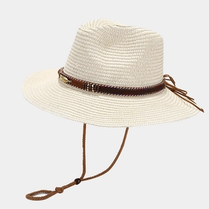 Detail of woven straw hat featuring metallic feathers, beads, and adjustable chin strap
