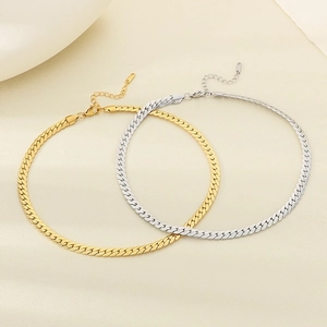 Flat gold and silver plated snake bone chains with lobster clasps on soft fabric
