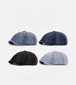 Detail view of washed denim newsboy caps in four vintage shades including blue and black