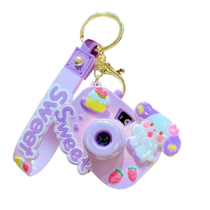 Cute purple Sanrio-style camera keychain with cartoon dog and sweet dessert charms