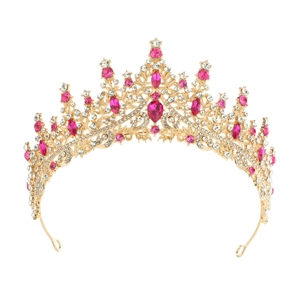 Detailed view of golden crown headpiece with pink teardrop gems and clear rhinestones