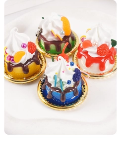Detailed macro view of four mini artificial cakes with cream and fruit toppings