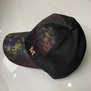 Close-up of black mesh baseball cap with rainbow leopard print and gold metal M logo