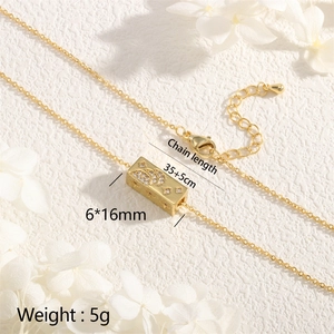 Macro detail of gold 18K plated star and moon pendant with dimensions 6x16mm