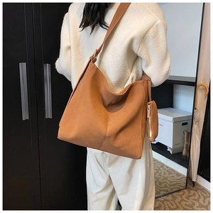 Detail of caramel brown tote bag set with wide shoulder strap and detachable pouch