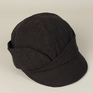 Detailed close-up of textured woven fabric and short brim on this vintage newsboy hat