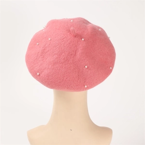 Detail showing the pink wool cashmere beret adorned with elegant white pearl beads