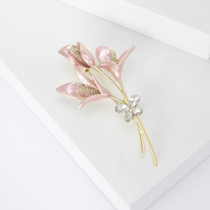Detailed close-up of pink enamel tulip brooch with golden stems and sparkling crystals