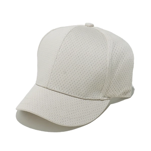 Close-up of beige mesh baseball cap showing breathable holes and durable polyester texture