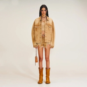 Distressed vintage yellow denim jacket set with matching shorts and leather boots