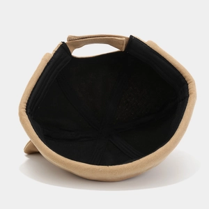 Detail view of khaki docker hat interior with reinforced stitching and adjustable strap