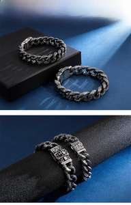 Macro detail of 304 stainless steel skull clasp with antique floral engravings on retro chain