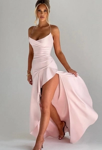 Pink satin slip dress detail featuring ruffled high slit and elegant draped hemline