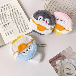 Plush penguin coin purses in grey, pink, and blue showing storage for AirPods and keys