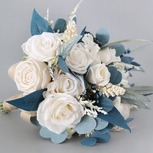 Elegant cascading bridal bouquet with white roses and navy blue foliage for wedding photography