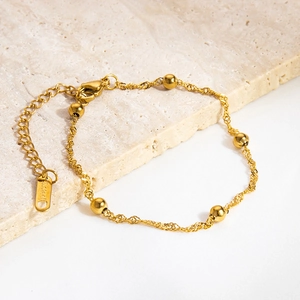 Macro shot of 18K gold plated stainless steel rope chain with round beads and lobster clasp