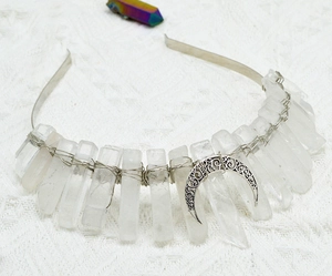 Macro detail of raw white crystal stones and silver crescent moon on handmade headband