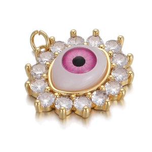 Pink evil eye charm with clear cubic zirconia in gold plating and white background