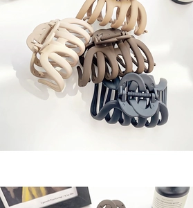 Close-up of matte pumpkin hair claws in beige, light brown, dark brown, and grey colors