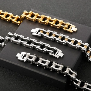 Industrial style bicycle chain bracelets in gold and silver steel on jewelry box