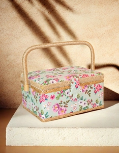 Floral fabric sewing basket with mint green rose pattern on a natural stone base