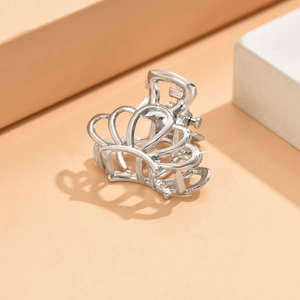 Detailed view of silver crown metal hair claw clip with star glint highlights