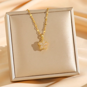 Rotating four-leaf flower pendant necklace in gold stainless steel with cubic zirconia