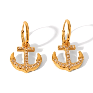 Close-up of anchor-shaped 18K gold stainless steel earrings with sparkling zircon inlay