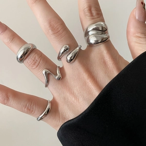 Macro detail of molten liquid metal rings set with irregular mirror polished finish