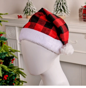 Close-up of a festive red and black plaid Christmas hat with white plush trim and pom-pom