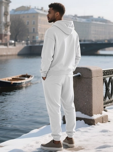 Men's white tracksuit with textured waffle knit pattern shown in outdoor street style
