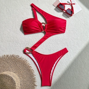 Detailed flat lay of red cutout one-shoulder swimsuit with golden metallic rings