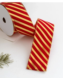 Detail of red and gold striped Christmas ribbon roll with metallic gilding on fabric