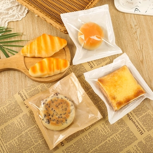 Greaseproof kraft paper bags and clear plastic packaging for toast bread and croissants