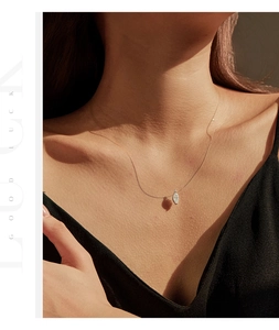 Elegant silver leaf pendant on delicate chain necklace worn by a female model