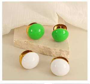 Detailed close-up of French vintage gold-plated dome stud earrings in green and white