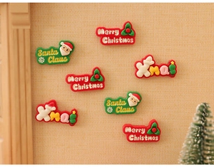 Detailed view of colorful resin Santa Claus and Merry Christmas miniature festive ornaments