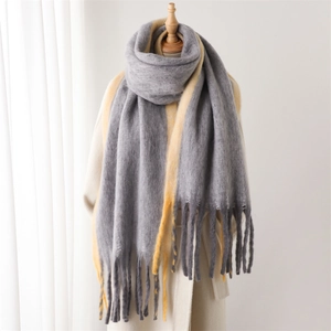 Detail of gray and yellow color-block cashmere-like scarf with soft fringe texture
