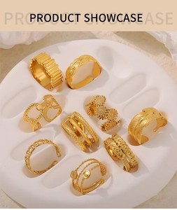 Details von 18K vergoldeten Vintage-Ringen mit Blattgravur auf weißem Präsentations-Tablett
